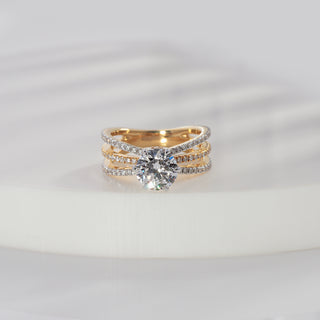 Round cut lab grown diamond split shank engagement ring in yellow gold with three pavé rows and six-prong center