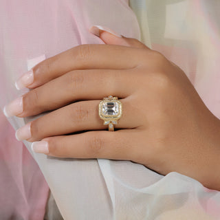 Emerald cut lab grown diamond vintage engagement ring in yellow gold with bezel center, marquise side diamonds and engraved shoulders