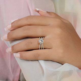 Round cut lab grown diamond split shank engagement ring in yellow gold with three pavé rows and six-prong center