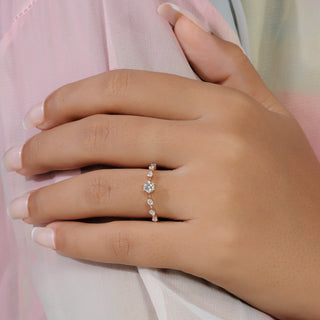 Round cut lab grown diamond side stone engagement ring in rose gold with graduated round diamond shoulders