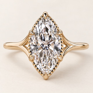 Marquise cut lab grown diamond engagement ring with 2.00 ct center, protective pointed-end prongs, fine milgrain edging and open split-shank shoulders in yellow gold.