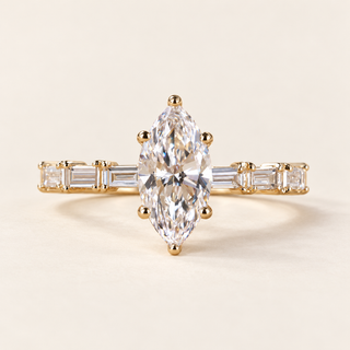Marquise cut lab grown diamond engagement ring with 1.00 ct center, six-prong setting, protective tip prongs and six baguette diamond accents in yellow gold.
