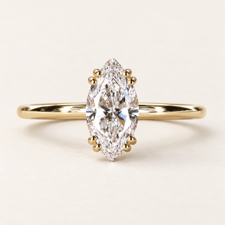 Marquise lab grown diamond engagement ring in yellow gold with eight rounded prongs in four pairs and a plain polished band