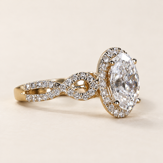 Oval cut lab grown diamond halo engagement ring with a 1.50 ct center, pavé halo and twisted diamond crossover shoulders in yellow gold with white-tone prongs.