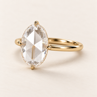Oval rose cut lab grown diamond engagement ring in yellow gold with four claws at the ends and side midpoints and a plain polished band