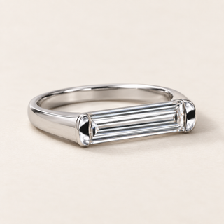 East-west baguette lab grown diamond bezel engagement ring in white gold with rounded metal end caps and a plain polished band