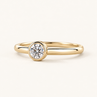 Round lab grown diamond bezel engagement ring in yellow gold with a polished 2.00 mm band and a continuous circular rim