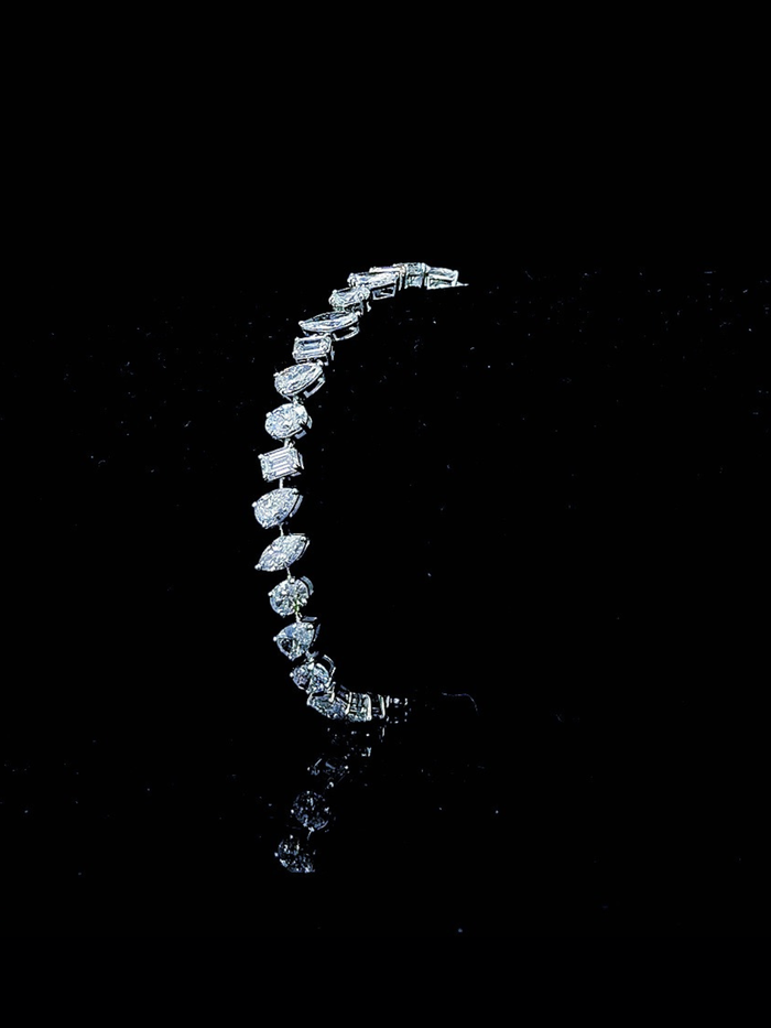 White gold mixed-shape tennis bracelet with 6.83ct lab grown diamonds photographed on black