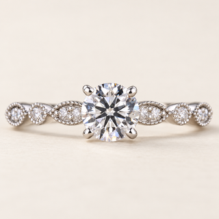 Round lab grown diamond vintage milgrain engagement ring in white gold with four-prong center, beaded leaf shoulders and diamond accents