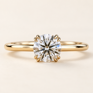 Round lab grown diamond engagement ring in yellow gold with eight prongs arranged in four pairs and a plain polished band