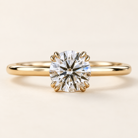 Round lab grown diamond engagement ring in yellow gold with eight prongs arranged in four pairs and a plain polished band