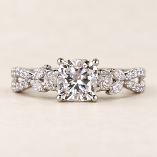 Cushion cut lab grown diamond engagement ring with 1.50 ct center, marquise and round diamond trellis shoulders, four-prong setting and polished white gold band.