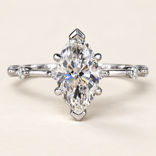 Marquise lab grown diamond solitaire engagement ring in white gold with V-shaped tip guards, four side claws and spaced round shoulder diamonds