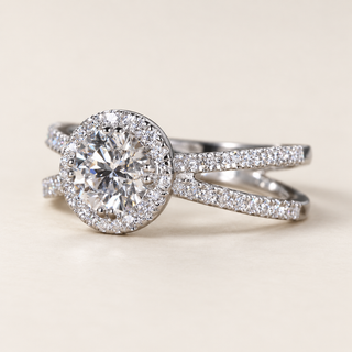 Round lab grown diamond engagement ring in white gold with pavé halo, double-row split shank and diamond-set crossover shoulders