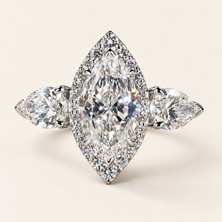 Marquise lab grown diamond three-stone engagement ring in white gold with pear side diamonds, pavé halo and protective V-prongs