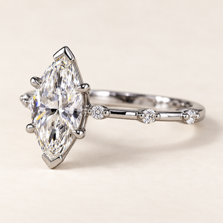 Marquise lab grown diamond solitaire engagement ring in white gold with V-shaped tip guards, four side claws and spaced round shoulder diamonds