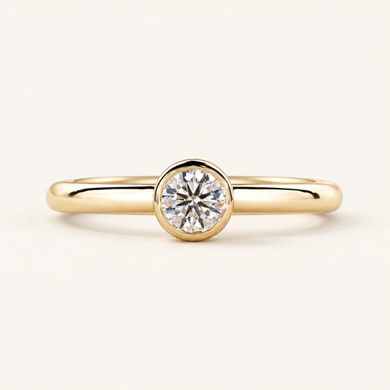 Round lab grown diamond bezel engagement ring in yellow gold with a polished 2.00 mm band and a continuous circular rim