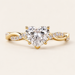 Heart cut lab grown diamond engagement ring with 1.00 ct center, protective point prong and twisted crossover pavé shoulders in polished yellow gold.