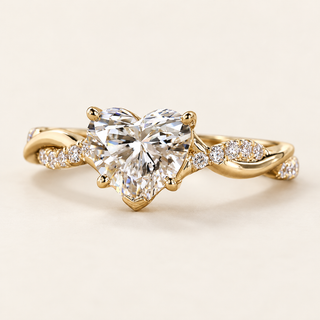 Heart cut lab grown diamond engagement ring with 1.00 ct center, protective point prong and twisted crossover pavé shoulders in polished yellow gold.