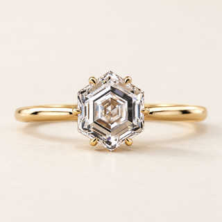 Hexagon step cut Lab Grown Diamond solitaire engagement ring in Yellow gold with a six-prong cathedral basket.