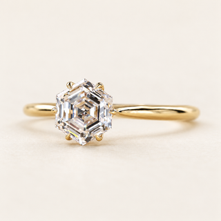 Hexagon step cut Lab Grown Diamond solitaire engagement ring in Yellow gold with a six-prong cathedral basket.