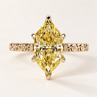 Fancy yellow Dutch marquise cut lab grown diamond engagement ring with protective pointed-end prongs, engraved floral shoulders and milgrain detailing in polished yellow gold.