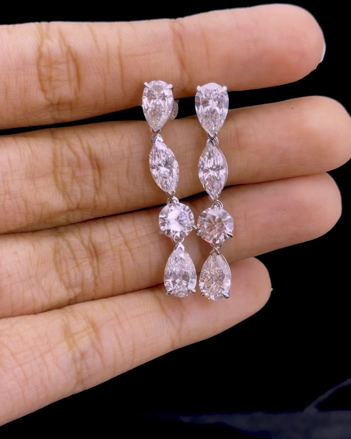 White gold drop earrings with 8.14ct pear, marquise and round lab grown diamonds on black
