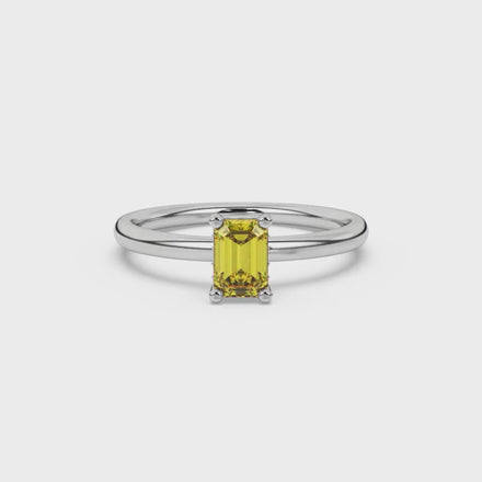 Emerald cut yellow gemstone halo ring with round diamond halo and polished gold band