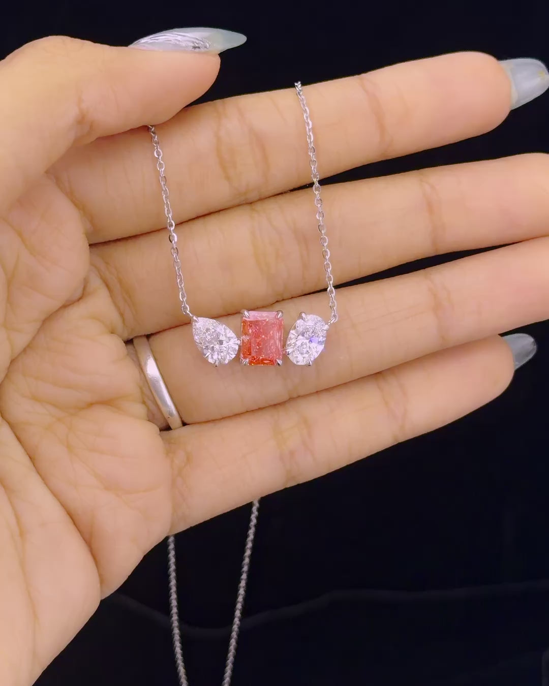 Main: White gold pink radiant pendant with pear and oval lab grown diamond side stones
Detail: Close-up of 2.81ct pink radiant lab grown diamond between pear and oval diamonds
Side: White gold three-stone pendant showing pink radiant, pear and oval lab grown diamond settings