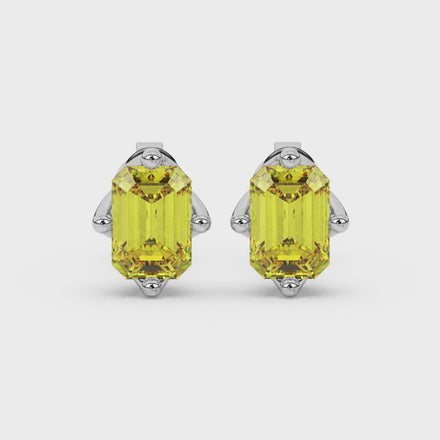 Emerald cut yellow gemstone solitaire stud earrings in fine gold setting