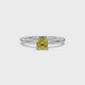 Yellow cushion cut gemstone solitaire ring in gold featuring a refined four-prong cathedral basket setting