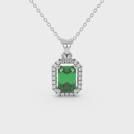 Emerald cut green gemstone halo pendant with round diamond accents