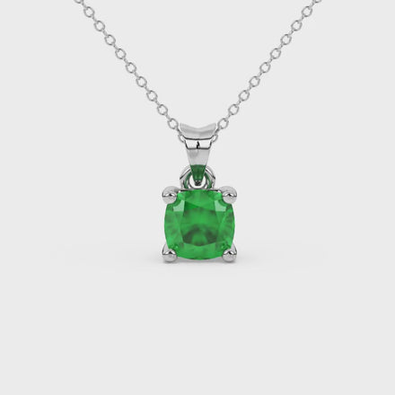 Green cushion cut gemstone solitaire pendant in gold featuring a refined four-prong basket setting