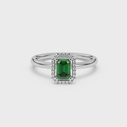 Green emerald cut gemstone halo ring with split shank band and diamond accents