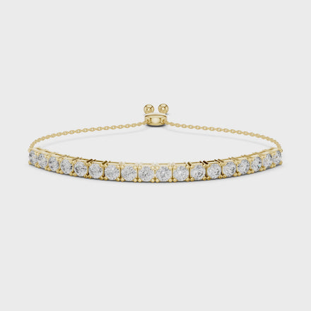 yellow gold bracelet with clear gemstones on a white background