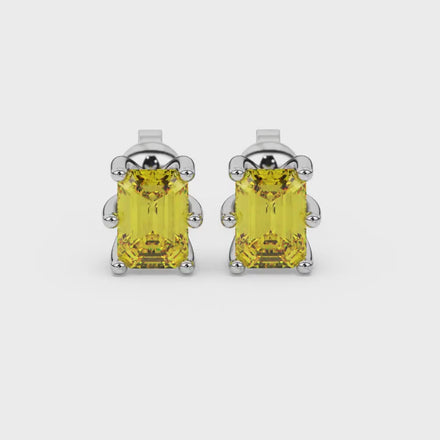 Emerald cut yellow gemstone solitaire stud earrings in gold with six prong setting