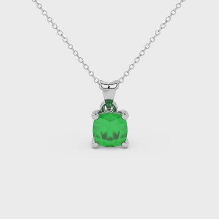 Green cushion cut gemstone pendant with accent diamonds in white gold basket setting