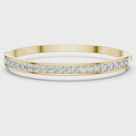 Channel set lab grown diamond bangle bracelet in yellow gold white gold and rose gold with sleek round diamond design