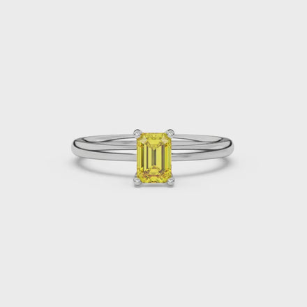 Emerald cut yellow gemstone ring featuring elegant solitaire setting