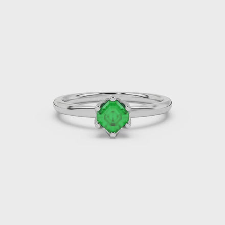 Asscher cut solitaire ring featuring a vibrant green gemstone secured in a six-prong crown setting crafted in gold