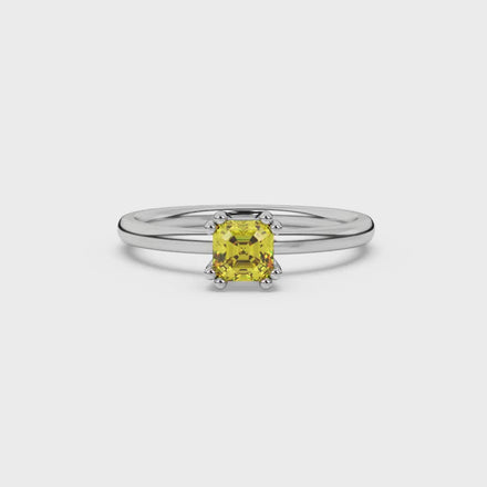 Yellow Asscher cut gemstone solitaire ring in gold featuring a refined six-prong basket setting