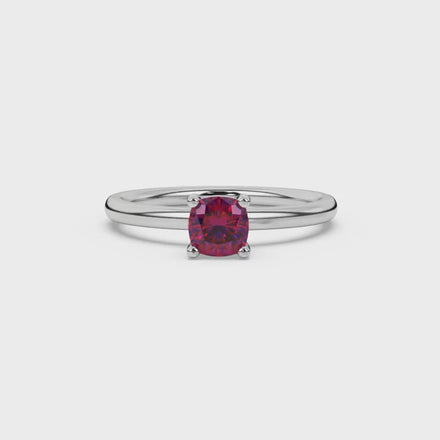 Red cushion cut solitaire gemstone ring in white gold four-prong setting