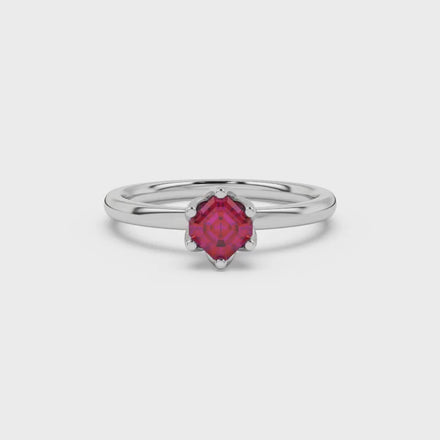 Asscher cut solitaire ring featuring a rich red gemstone secured in a six-prong crown setting crafted in gold