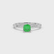 Green cushion cut solitaire gemstone ring in six-prong gold setting with slim stackable band