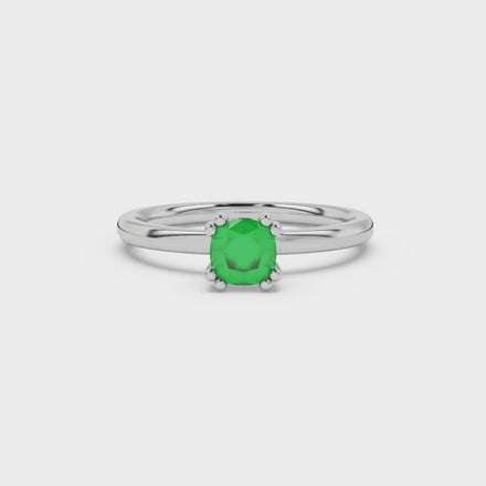 Green cushion cut solitaire gemstone ring in six-prong gold setting with slim stackable band