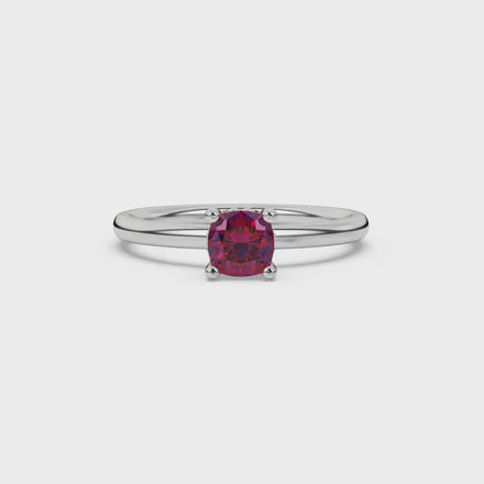 Red cushion cut solitaire gemstone ring in rose gold with classic four prong setting