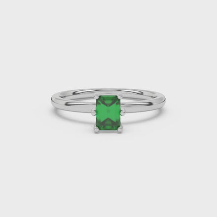 Emerald cut green gemstone solitaire ring in six prong gold setting