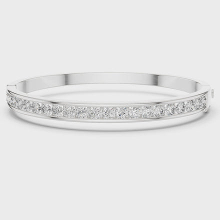 Channel set lab grown diamond bangle bracelet in yellow gold white gold and rose gold with sleek round diamond design
