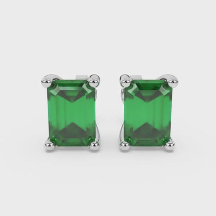 Emerald cut green gemstone solitaire stud earrings in rose gold four prong setting