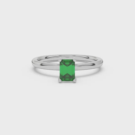 Emerald cut green gemstone solitaire ring in gold four prong setting